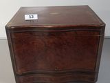 an old wooden chest with a label on the lid