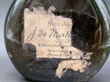 a glass bottle with a label on it that says joe trell