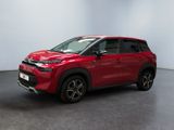 a red citrole is parked in a white room