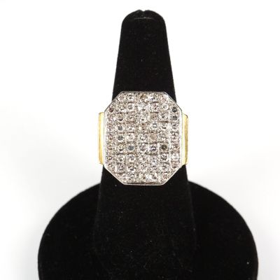 a close up of a diamond ring on a black ring stand