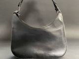 a close up of a black purse on a gray background