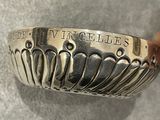 a close up of a silver spoon on a table
