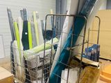 many rolls of fabric in a wire basket in a warehouse