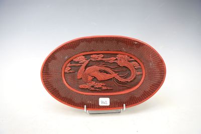 an image of a red and black plate with a dragon on it