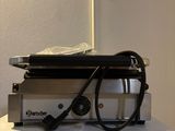 a laptop on a table with a pair of glasses on it