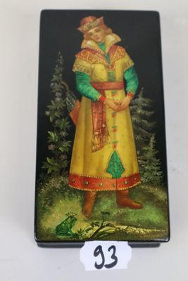 an image of a small tin box with a painting of a man in a yellow coat