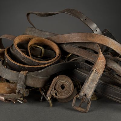 a pile of old belts and other items on a table