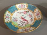a plate with a bird on it sitting on a table