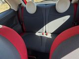 two seats in the back of a car that are red and grey