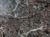 a crack in the marble floor of a bathroom