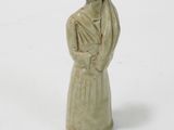 a figurine of a woman in a dress and hat