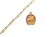 a close up of a gold chain bracelet with a gold coin on it