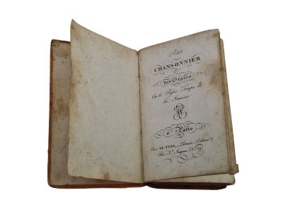 an old book opened to show a page with writing on it