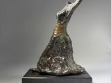 a bronze sculpture of a bird on a black base