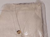 a white cloth with a button on it on a table