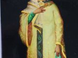 painting of a woman dressed in a yellow robe and a green shawl