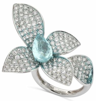 un gros plan d'une bague ornée d'une pierre couleur aqua en forme de fleur, entourée de diamants blancs