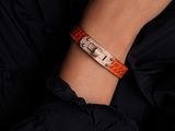 a close up of a person wearing a bracelet with a watch on it