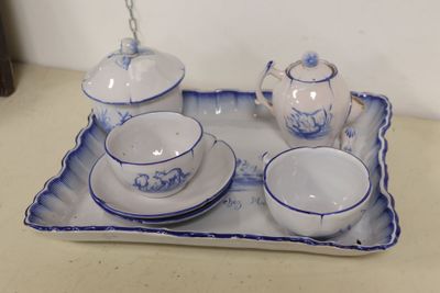 a blue and white tea set on a tray on a table
