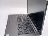 a laptop computer sitting on a table with a keyboard