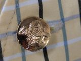 a button on a shirt that has a picture of a man ' s face on it