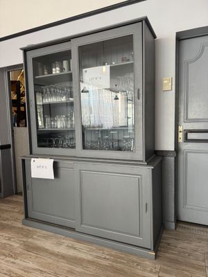 une armoire avec une porte vitrée au milieu de la pièce