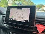 a gps device in the dashboard of a car with a leaf on the dashboard