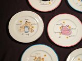 six plates with cartoon characters on them on a black surface