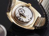 a close up of a watch on a black table