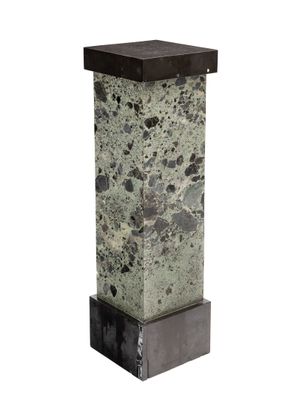 an image of a stone column with a metal base