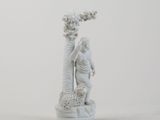 a white figurine of a man and a woman
