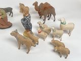 a lot of toy animals that are on a white surface