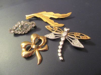 three brooches that are sitting on a table