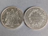 two silver coins, one of which is a woman and one of which is a man