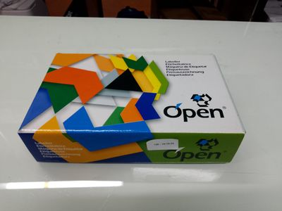 an open box of colorful paper sitting on top of a white table