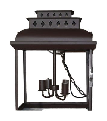 an image of a black lantern with two candles inside of it