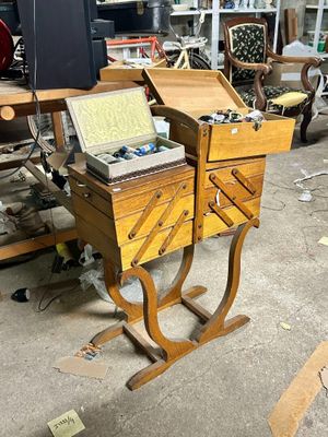 a small wooden desk with two drawers and a laptop on it