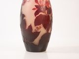 a vase that has a red and white design on it