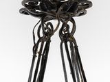 a close up of a metal sculpture of a bird on a branch