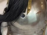a helmet with a long black hair on top of it