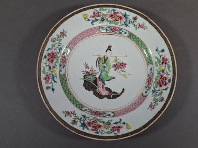 a plate with a picture of a woman riding a horse
