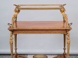 une table ancienne en bois avec un plateau en verre, posée sur un sol en damier