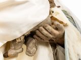 a statue of jesus holding a baby in his arms