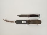 two knives that are laying on a white surface