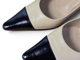 a pair of black and white shoes on a white surface