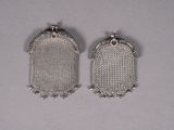 a pair of silver mesh earrings on a white surface