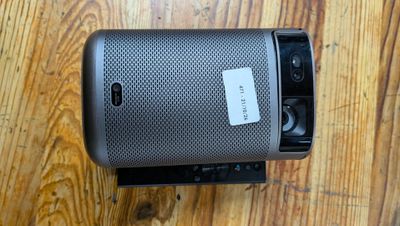 a close up of a speaker sitting on top of a wooden floor