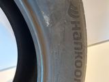 a close up of a tire on a white surface with a black rim