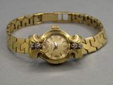 an image of a close up of a wrist watch on a table