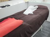 a bed with a brown blanket on it in a room